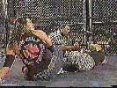 Raven executing a figure four leglock on Sandman in ECW